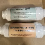 Two bidet water filters side by side: the ion filter with a green label and the sediment filter with an orange label
